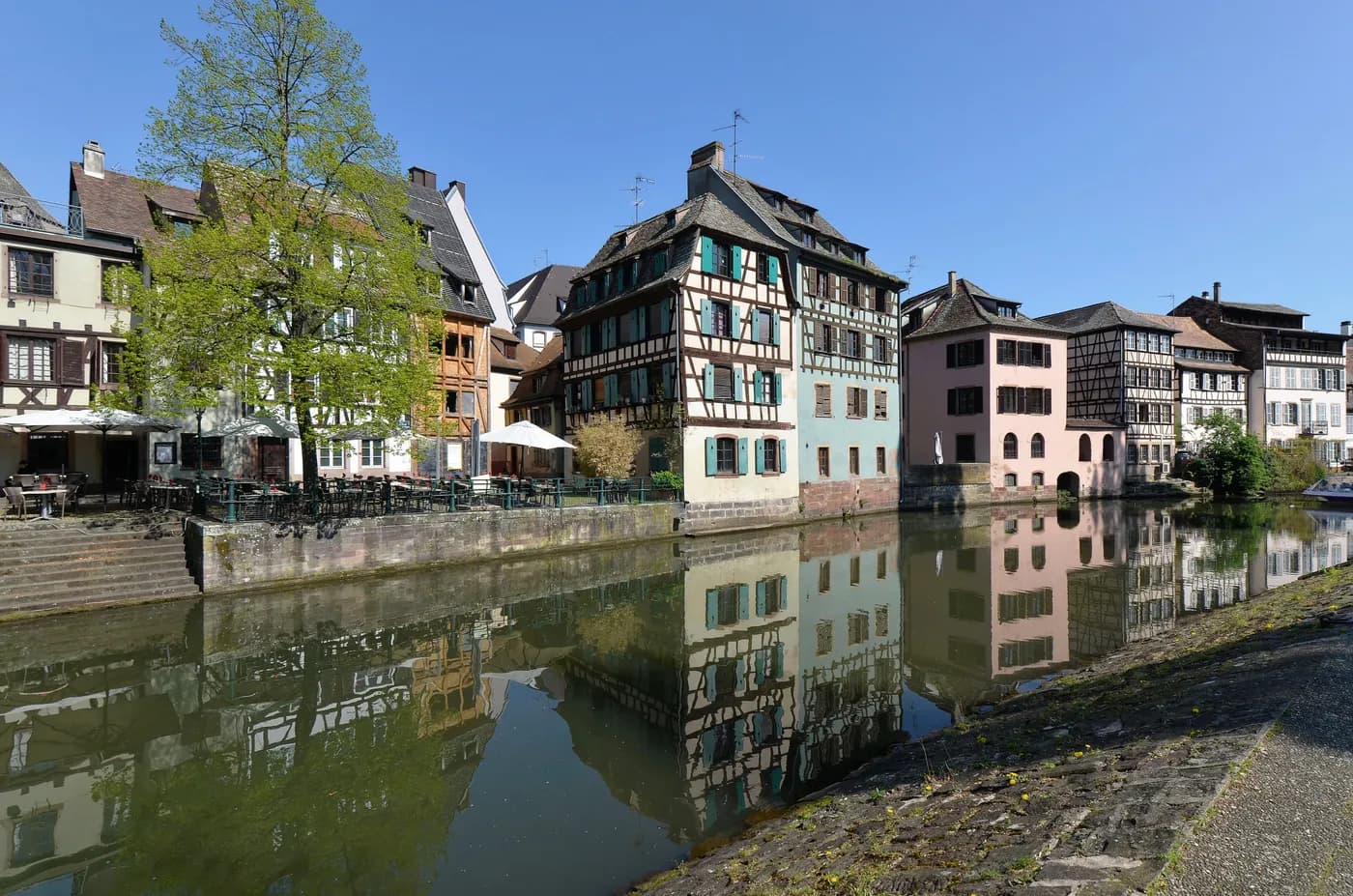 Half-timbered houses reflected in a canal in Strasbourg’s Petite France