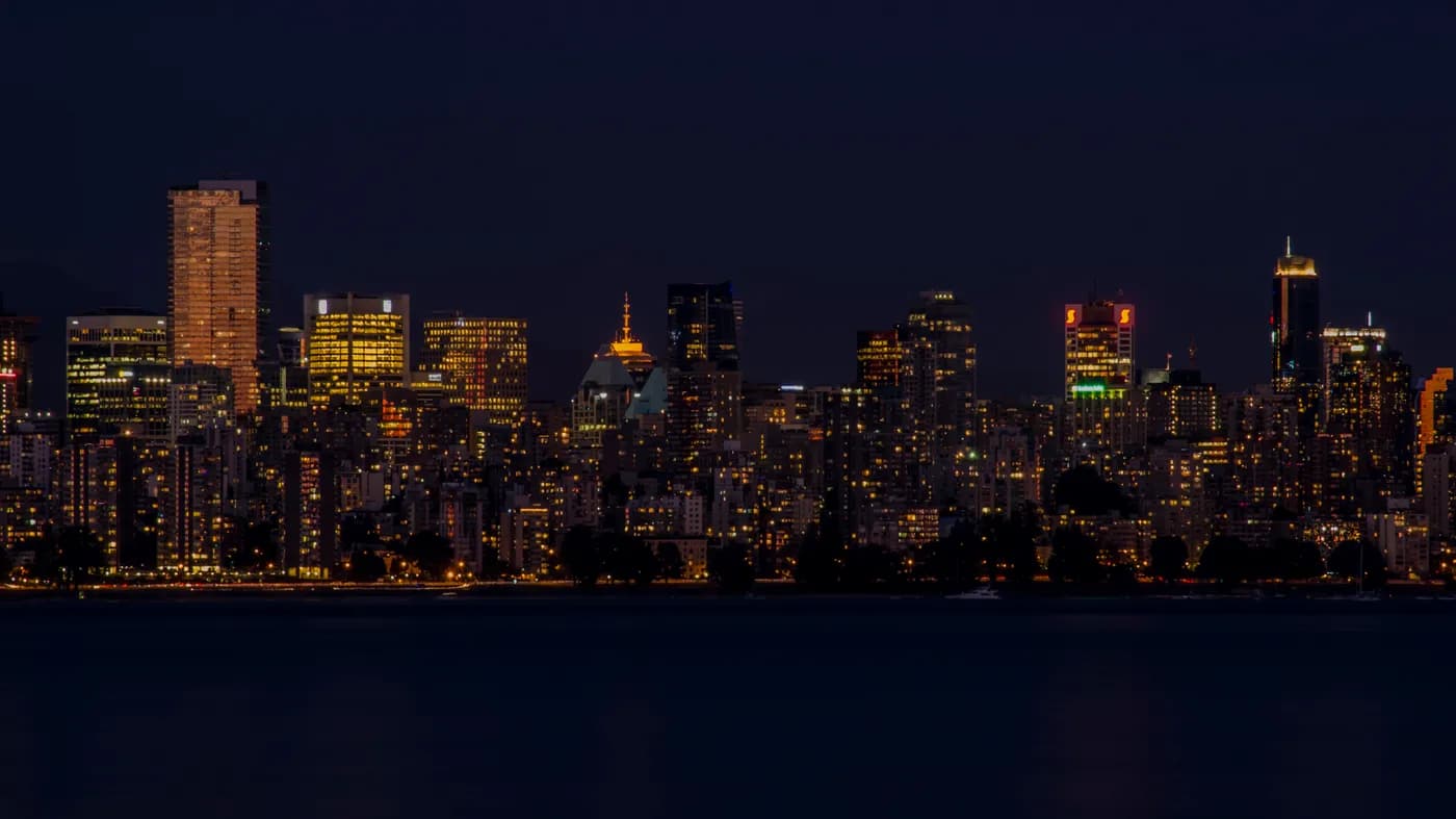 Vancouver skyline illuminated at night across the water