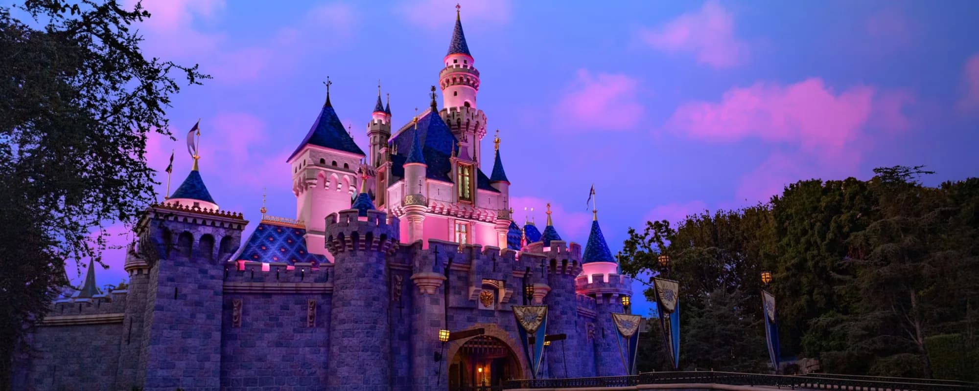 Sleeping Beauty Castle illuminated at dusk at Disneyland Park