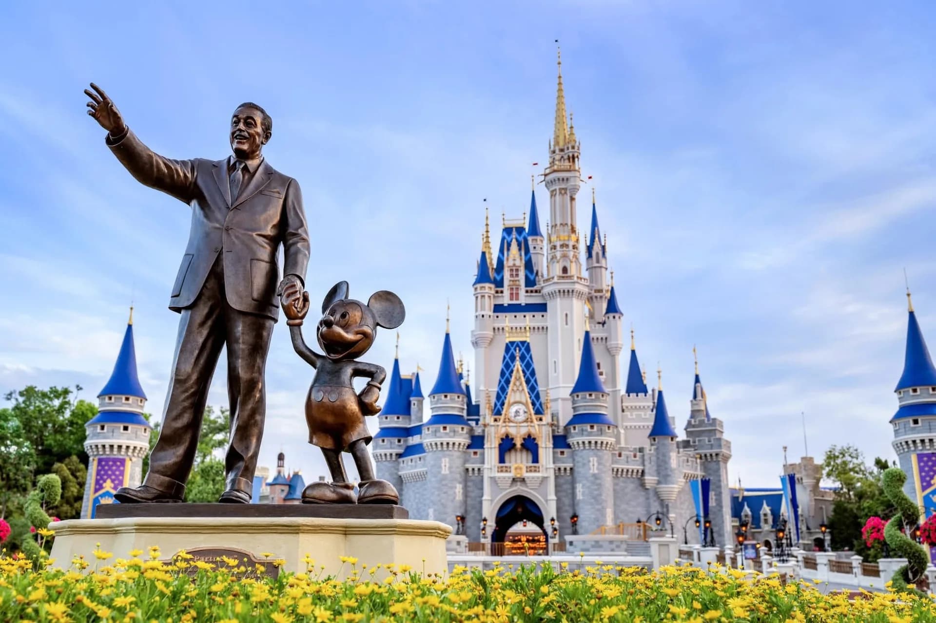 Walt Disney and Mickey Mouse statue in front of Cinderella Castle
